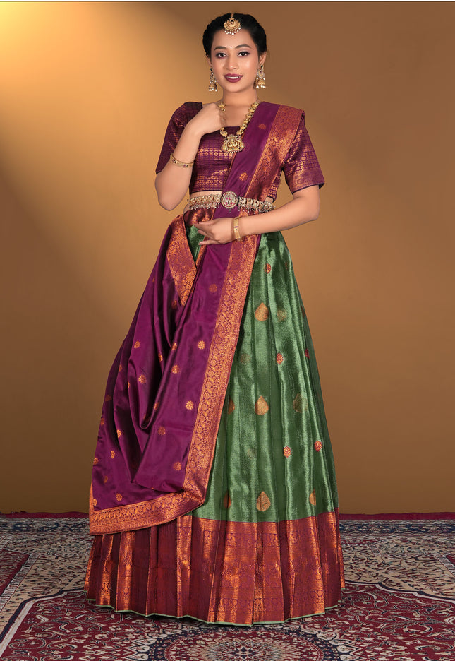 Woman wearing a traditional green and purple lehenga choli