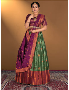 Woman wearing a traditional green and purple lehenga choli