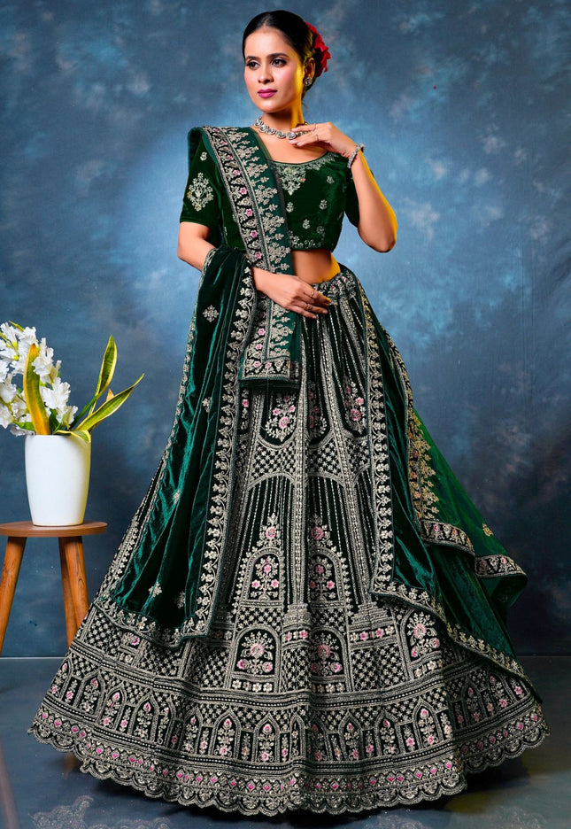 Woman in a green embroidered traditional lehenga choli with dupatta