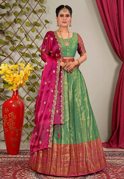 Woman in a green and pink traditional lehenga choli with matching blouse