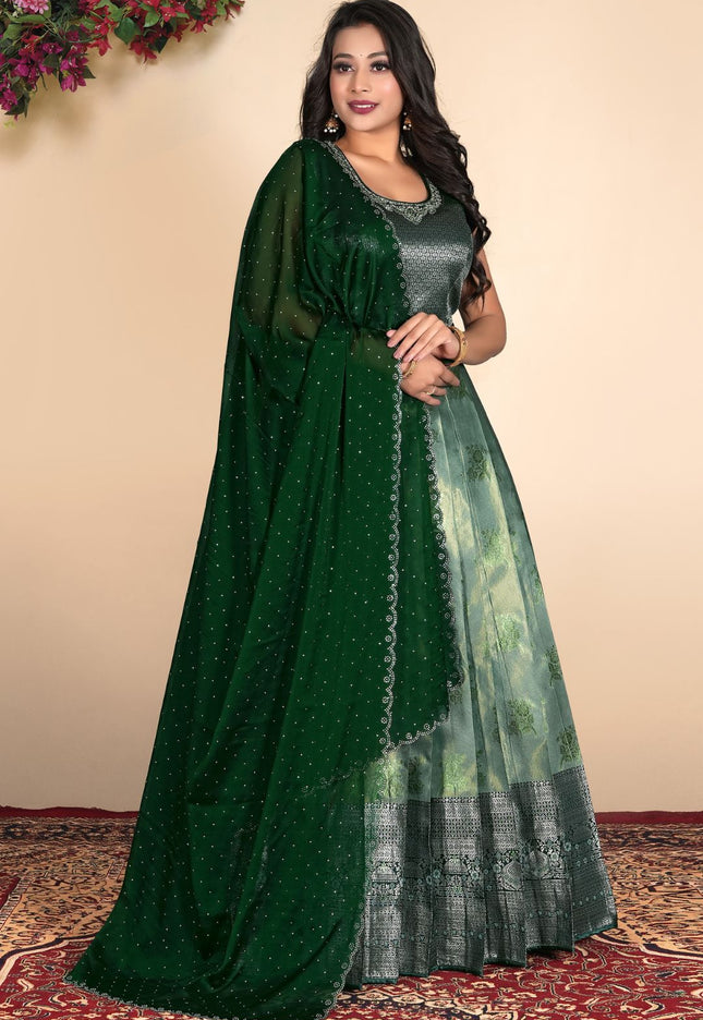 Woman wearing a green gown with a matching dupatta