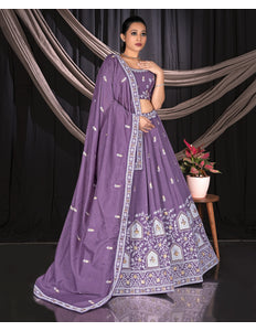 Woman wearing a purple traditional outfit with intricate designs