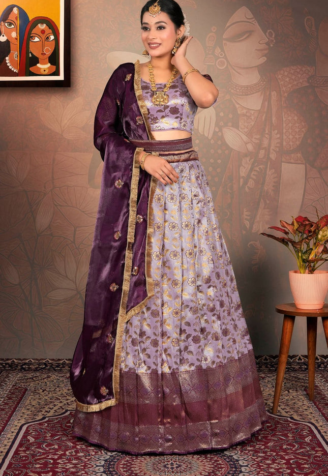 Woman in a traditional purple and lavender lehenga choli with dupatta