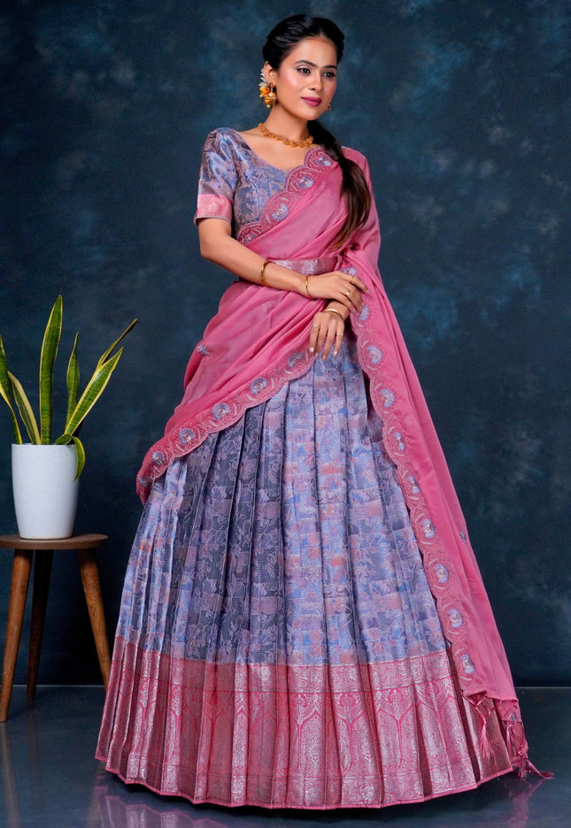 Woman wearing a pink and blue lehenga choli with dupatta