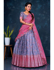 Woman wearing a pink and blue lehenga choli with dupatta