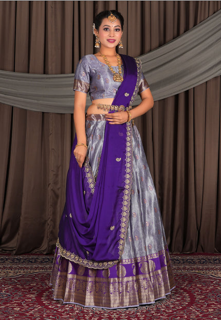 Woman wearing a traditional purple lehenga with a matching blouse