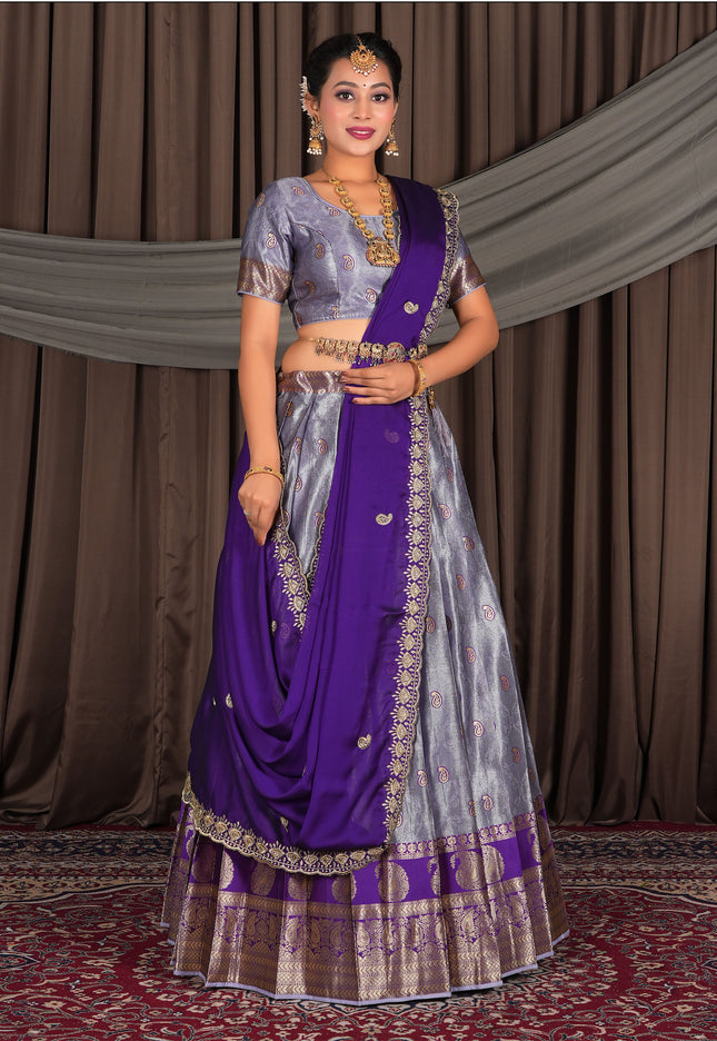 Woman wearing a traditional purple lehenga with a matching blouse