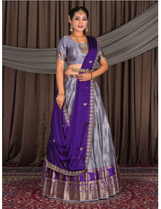 Woman wearing a traditional purple lehenga with a matching blouse