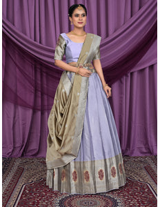Woman in a traditional lavender color lehenga choli with chiku dupatta