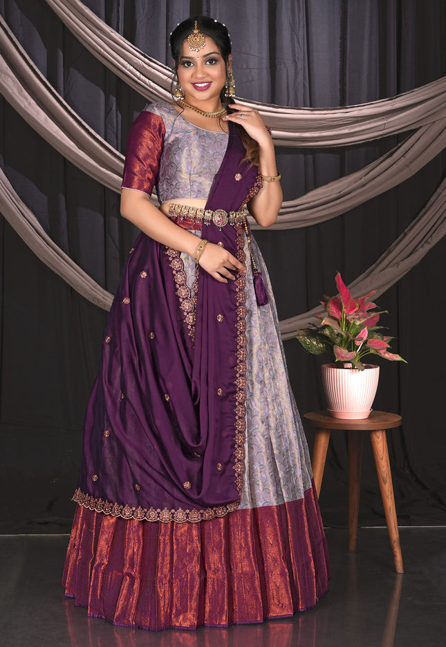 Woman in a traditional outfit with a Lavender and Wine contrast Lehenga