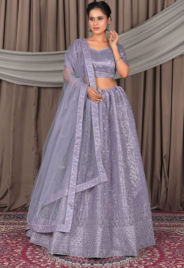 Woman in a lavender traditional outfit with a dupatta
