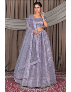 Woman in a lavender traditional outfit with a dupatta