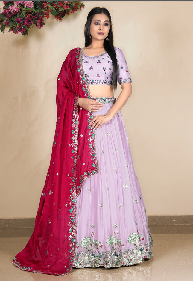 Woman wearing a pink and red traditional outfit with floral patterns
