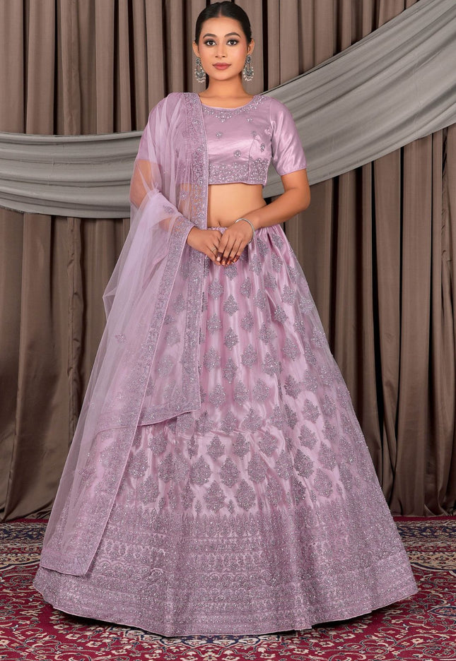 Woman wearing a pink traditional outfit with a patterned design
