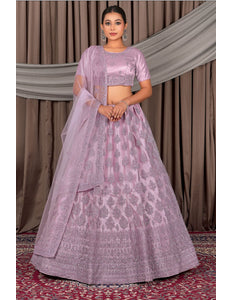 Woman wearing a pink traditional outfit with a patterned design
