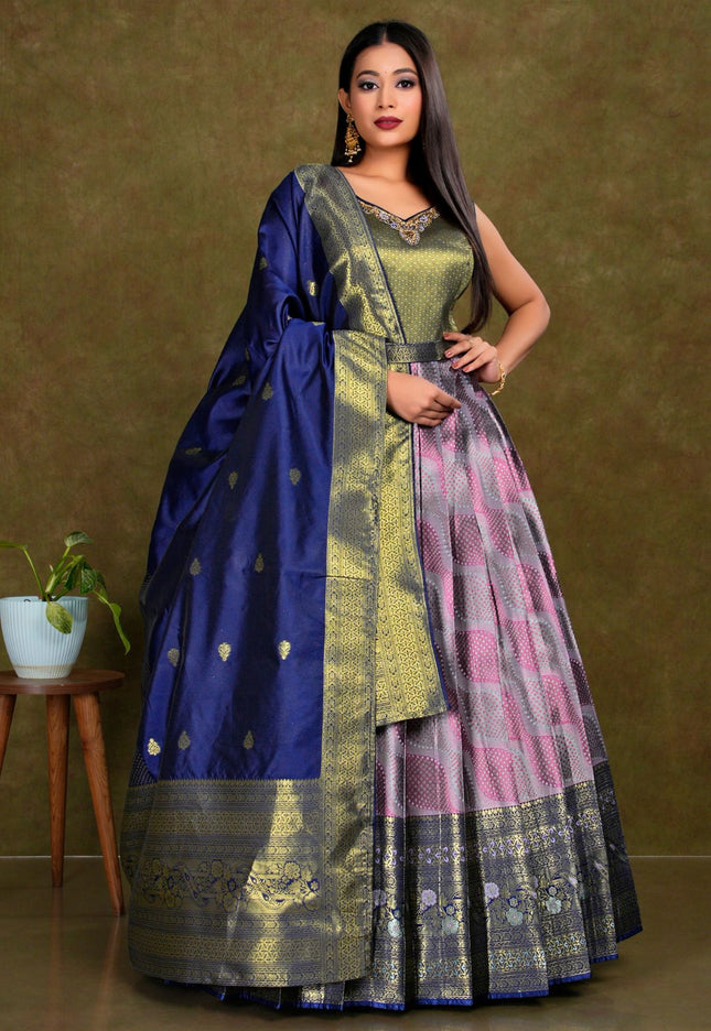 Woman wearing a traditional outfit with a lavender gown with blue dupatta