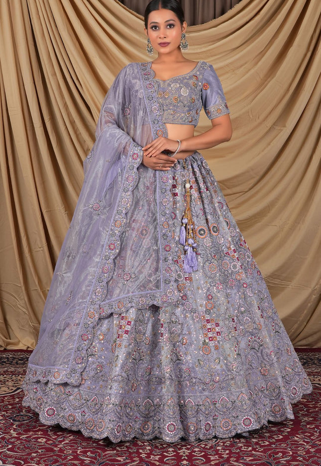 Woman wearing a traditional lavender embroidered lehenga choli with dupatta
