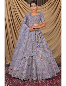 Woman wearing a traditional lavender embroidered lehenga choli with dupatta