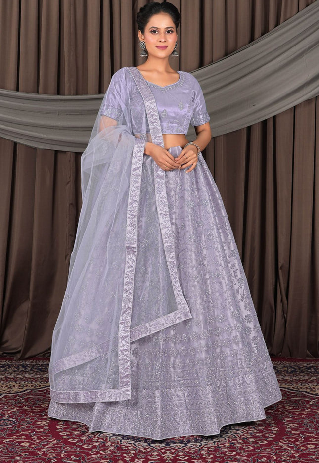 Woman wearing a light purple traditional outfit with a matching dupatta