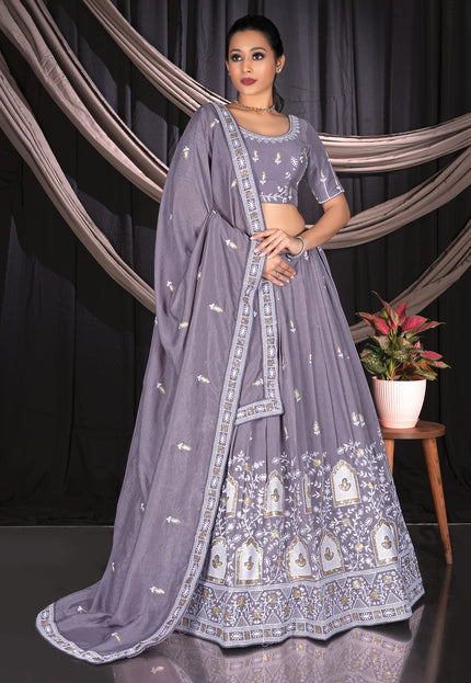 Woman in a lavender traditional outfit with intricate patterns