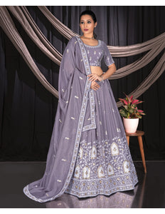 Woman in a lavender traditional outfit with intricate patterns