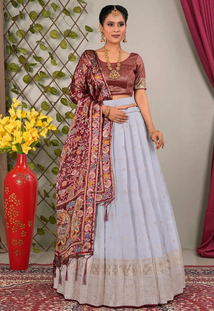 Woman in traditional outfit with a maroon and lavender lehenga choli
