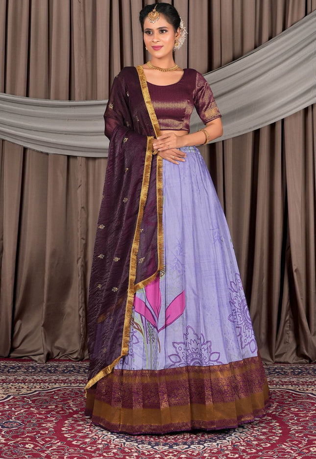 Woman wearing a traditional outfit with a purple blouse and light blue skirt