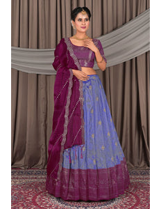 Woman wearing a traditional purple and blue outfit