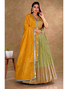 Woman wearing a mustard yellow and lemon long gown with dupatta