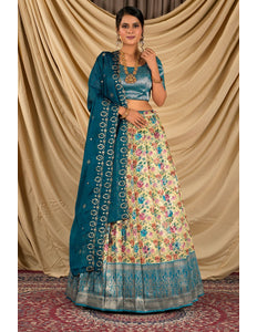 Woman wearing a traditional outfit with a floral skirt and blue dupatta