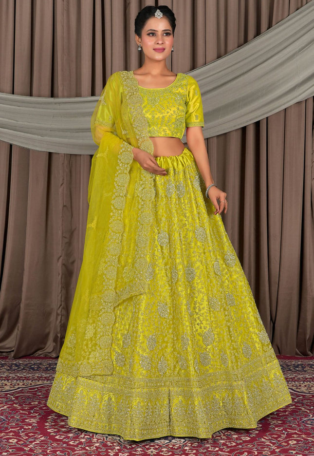 Woman wearing a bright yellow traditional outfit with intricate patterns