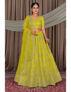 Woman wearing a bright yellow traditional outfit with intricate patterns
