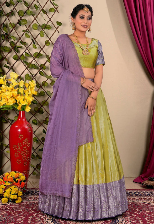 Woman wearing a green and purple lehenga choli with dupatta