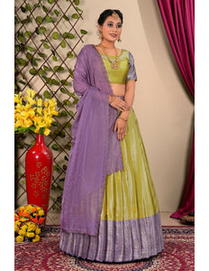 Woman wearing a green and purple lehenga choli with dupatta