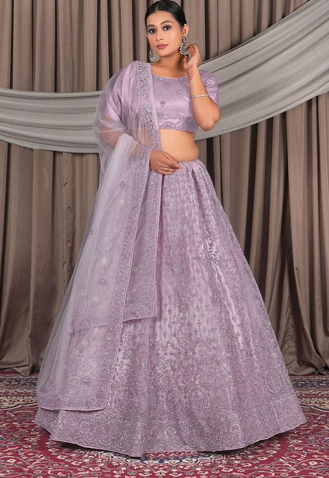 Woman wearing a lavender traditional outfit with a dupatta