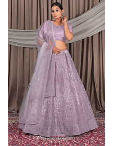 Woman wearing a lavender traditional outfit with a dupatta