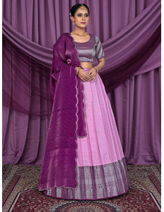 Woman wearing a traditional pink and purple lehenga choli