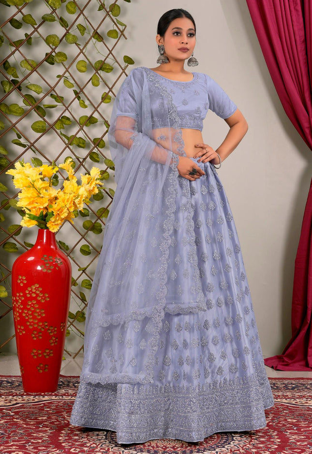 Woman in a light blue traditional outfit standing