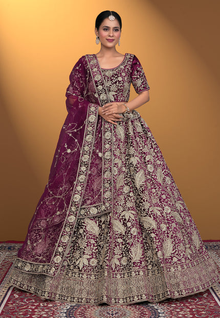 Woman wearing a traditional embroidered purple lehenga choli