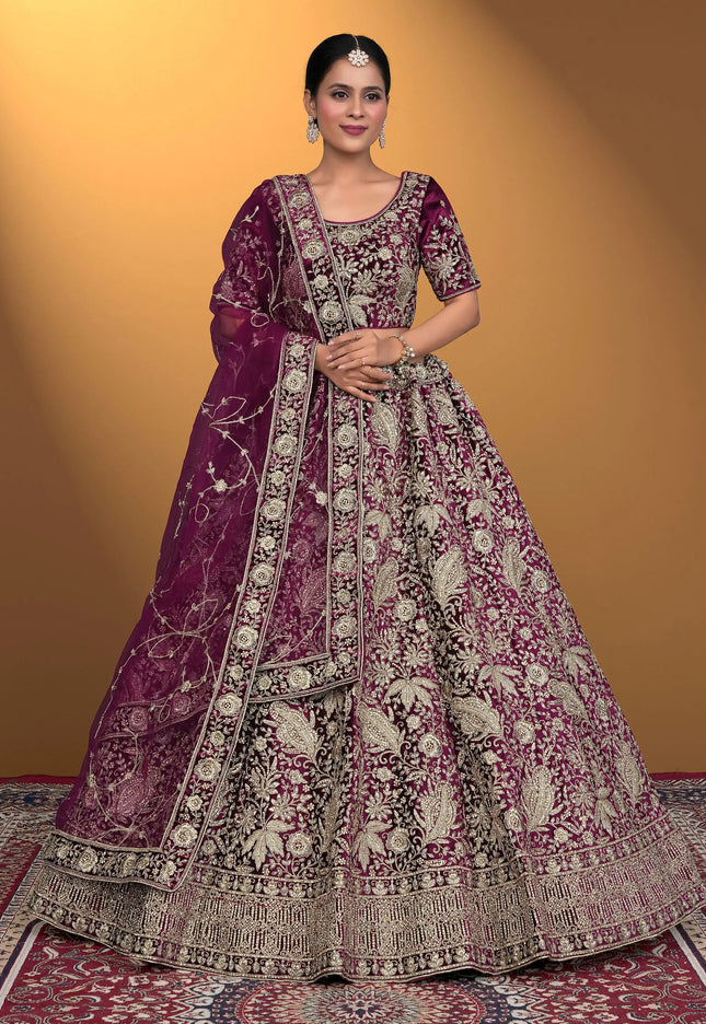Woman wearing a traditional embroidered purple lehenga choli