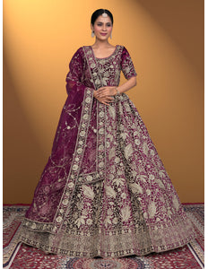 Woman wearing a traditional embroidered purple lehenga choli