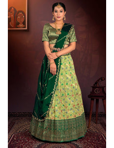 Woman in a green traditional outfit with a patterned lehenga choli
