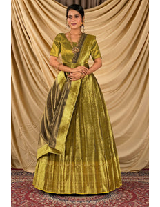 Woman wearing a green traditional outfit with a gold sash
