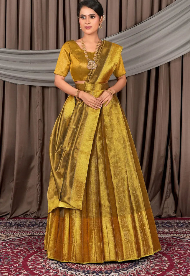 Woman wearing a gold traditional lehenga choli with dupatta