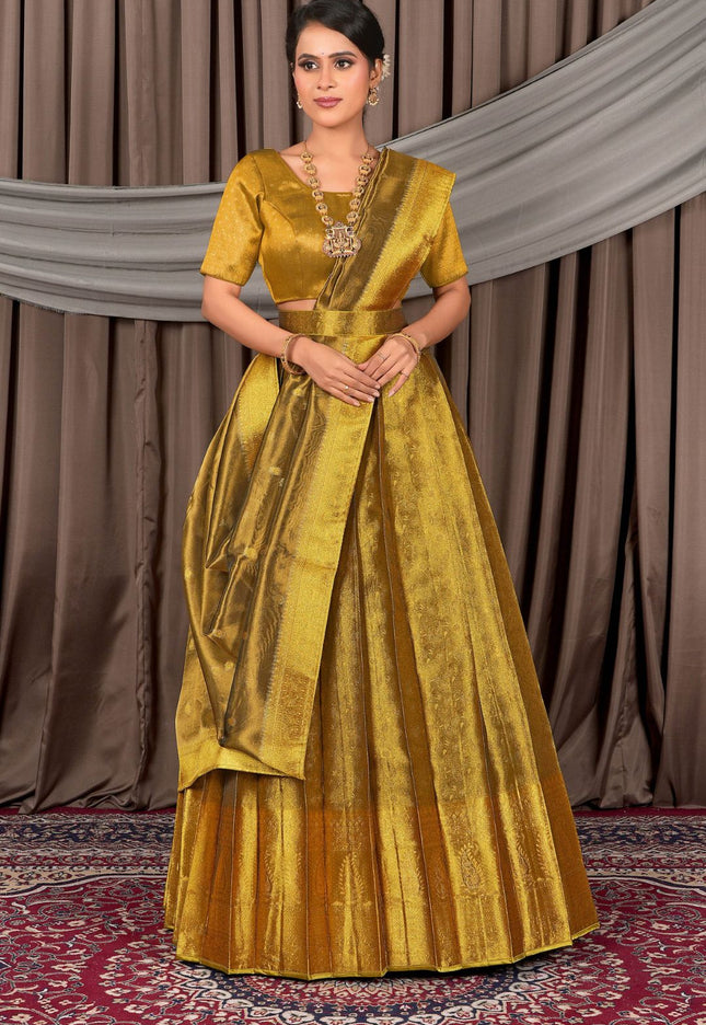 Woman wearing a gold traditional lehenga choli with dupatta