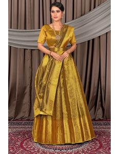 Woman wearing a gold traditional lehenga choli with dupatta