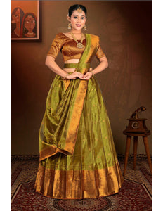 Woman wearing a traditional green and gold lehenga with a matching blouse