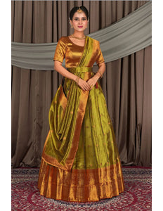 Woman wearing a traditional green and gold lehenga with a matching blouse
