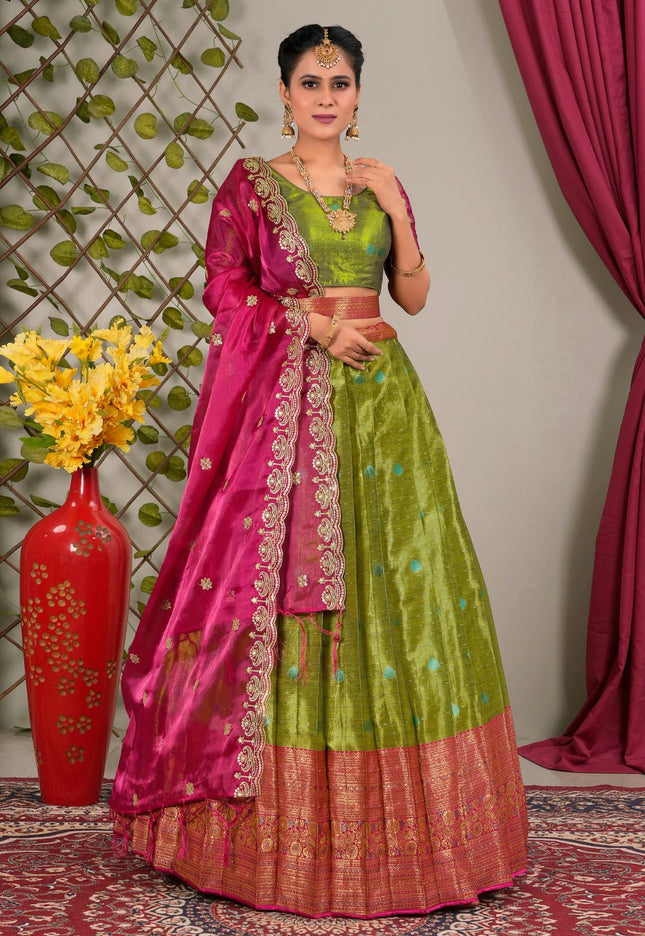 Woman wearing a green and pink traditional lehenga choli with dupatta