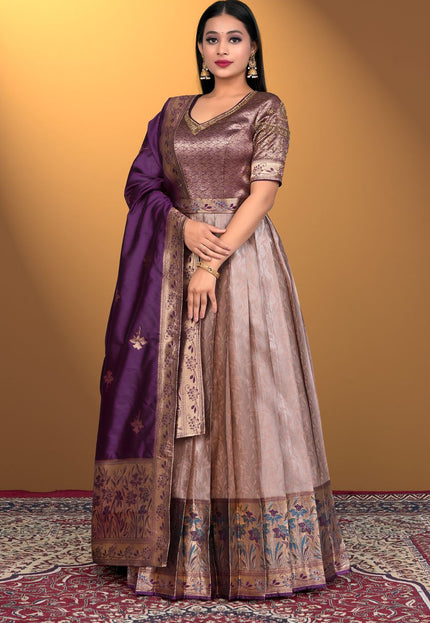 Woman wearing a traditional outfit with a purple dupatta
